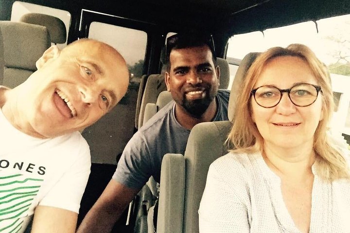 Guests and their tour host seated inside a vehicle