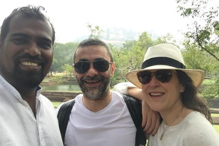Two guests and their tour host taking a selfie outdoors