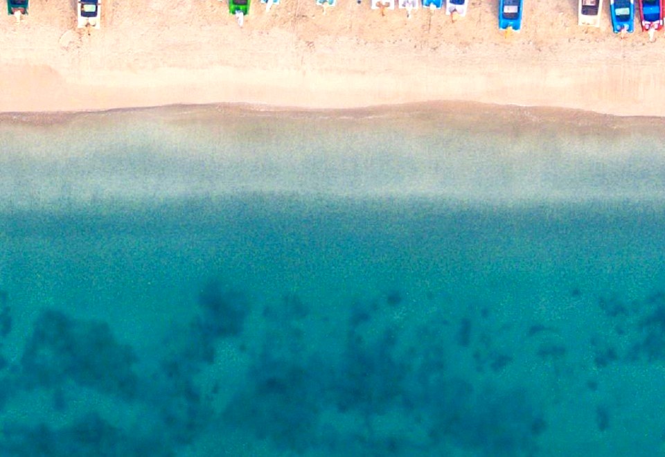 Clear turquoise water and empty shoreline at Pasikuda Beach