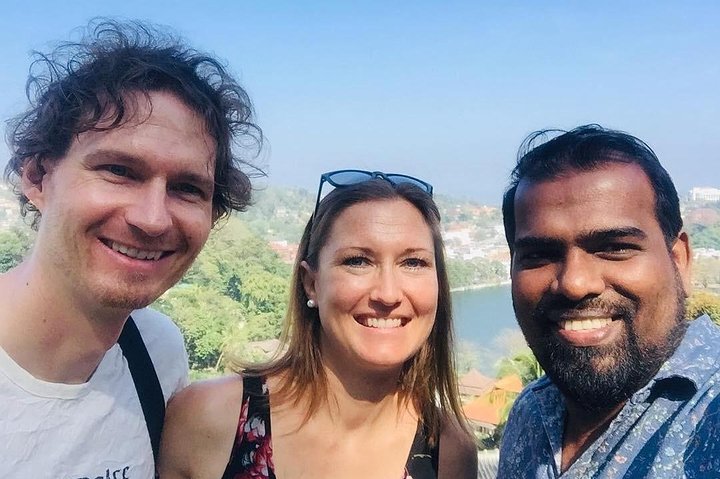 Guests and their tour host with a lake in the background