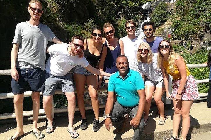 A group of travellers and their host on an outdoor walkway