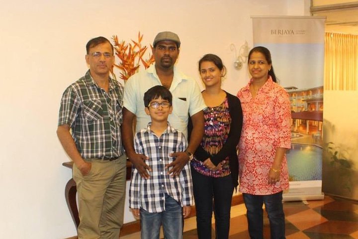 A family and their tour host together indoors