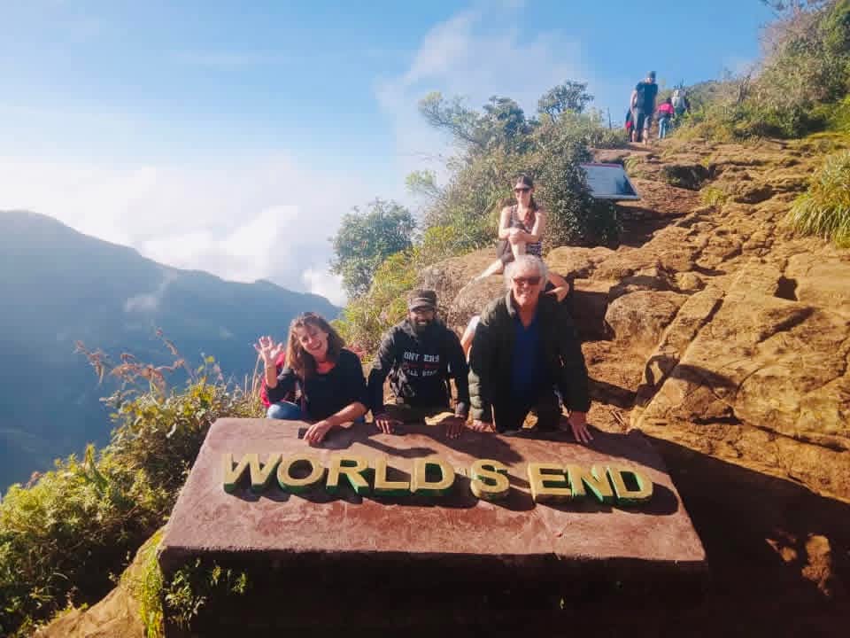 Guests with their tour host beside the World’s End sign at Horton Plains