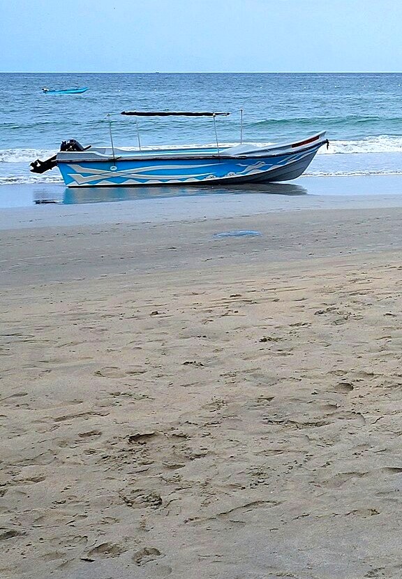 Fishing boat on an empty stretch of Trincomalee beach