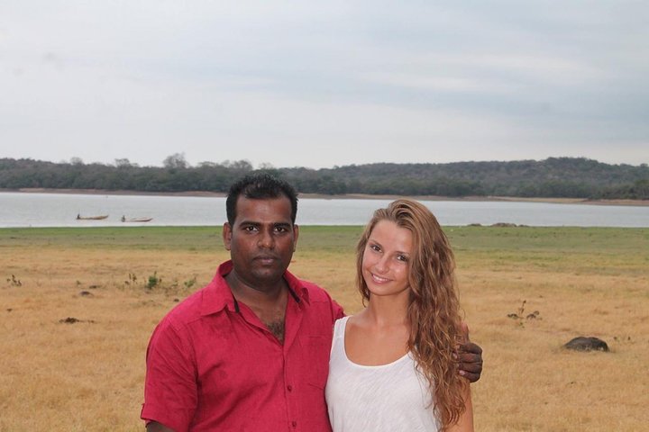 A guest and her tour host beside a lakeshore