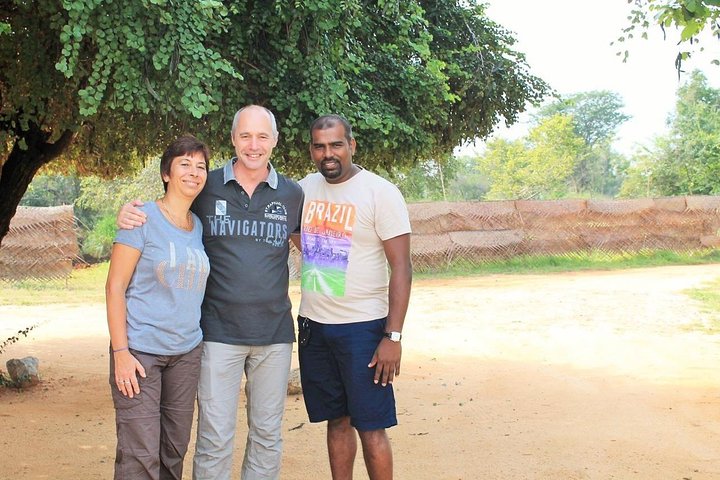 Guests and their tour host beneath a leafy tree