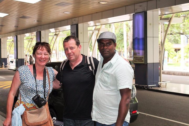 Guests with their tour host at an airport pick-up area